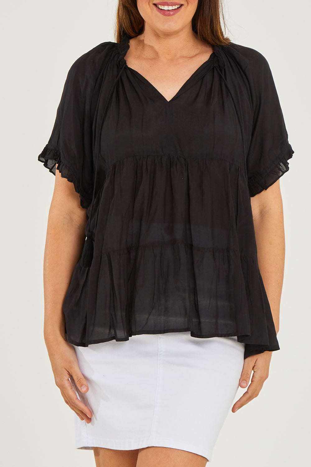 Model Georgia wearing size S of the Matilda Top in colour Black (Black), from the front, cropped image