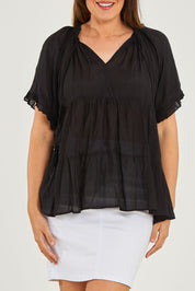 Model Georgia wearing size S of the Matilda Top in colour Black (Black), from the front, cropped image