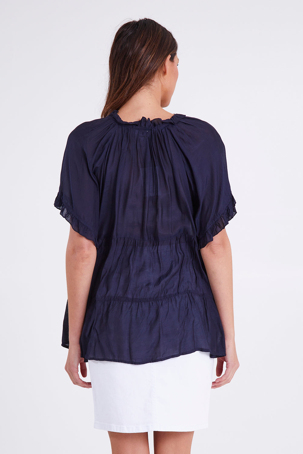 Model Madeline wearing size S of the Matilda Top in colour Navy (Blue), from the back