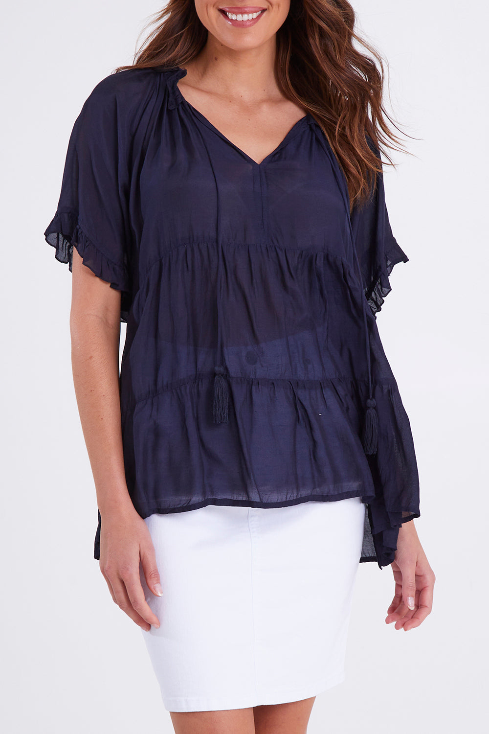Model Madeline wearing size S of the Matilda Top in colour Navy (Blue), from the front, cropped image