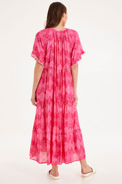 Model Madeline wearing size S of the Amisha S/S Maxi Dress in colour Pink (Pink), from the back