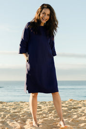 Model Ilona wearing size 10 of the Linen Reversible Shift Dress in colour Ocean (Blue), from the front, showing the whole outfit