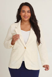 Model Ashleigh wearing size 16 of the Cotton Linen Longline Blazer in colour Cream, from the front, cropped image