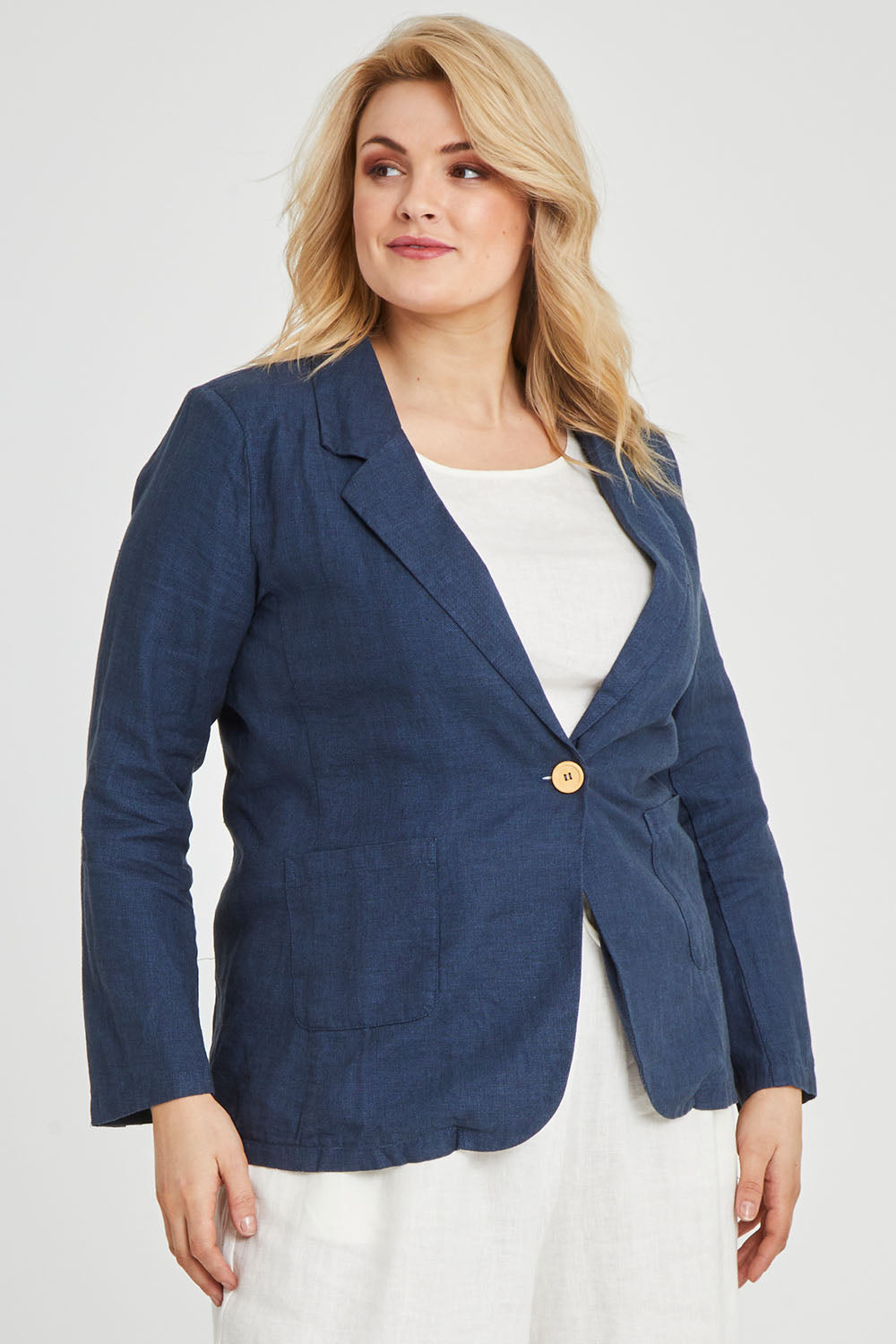 Model Keeara wearing size 16 of the Cotton Linen Longline Blazer in colour Deepocean (Blue), from the front, cropped image