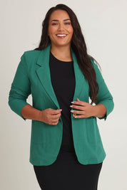 Model Ashleigh wearing size 16 of the Cotton Linen Longline Blazer in colour Green (Green), from the front, cropped image