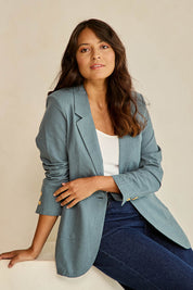 Model Tahnee wearing size 10 of the Cotton Linen Longline Blazer in colour Lagoon (Green), from the front, cropped image