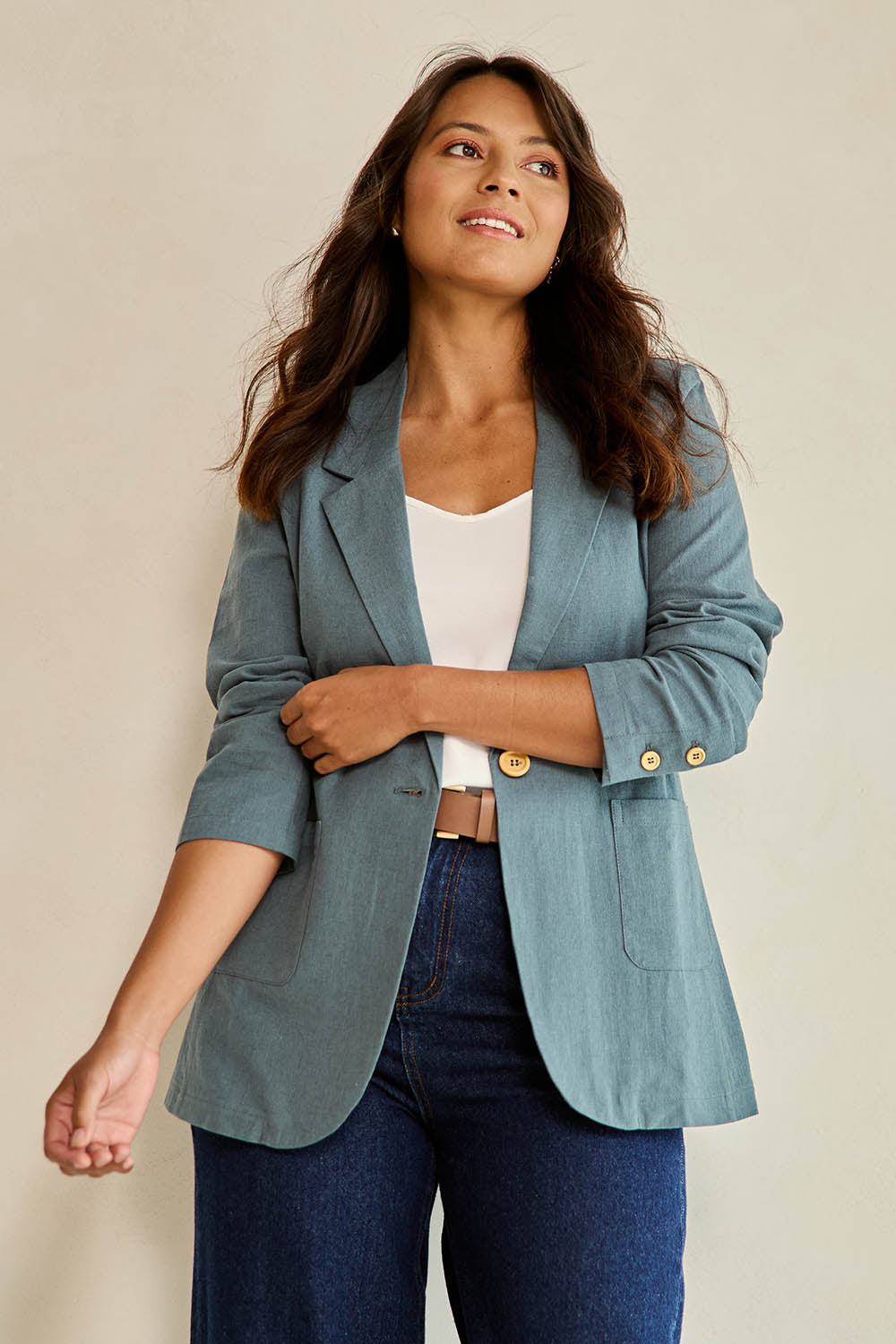 Model Tahnee wearing size 10 of the Cotton Linen Longline Blazer in colour Lagoon (Green), from the front, cropped image