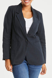 Model Noli wearing size 14 of the Cotton Linen Longline Blazer in colour Midnight (Black), from the front, cropped image