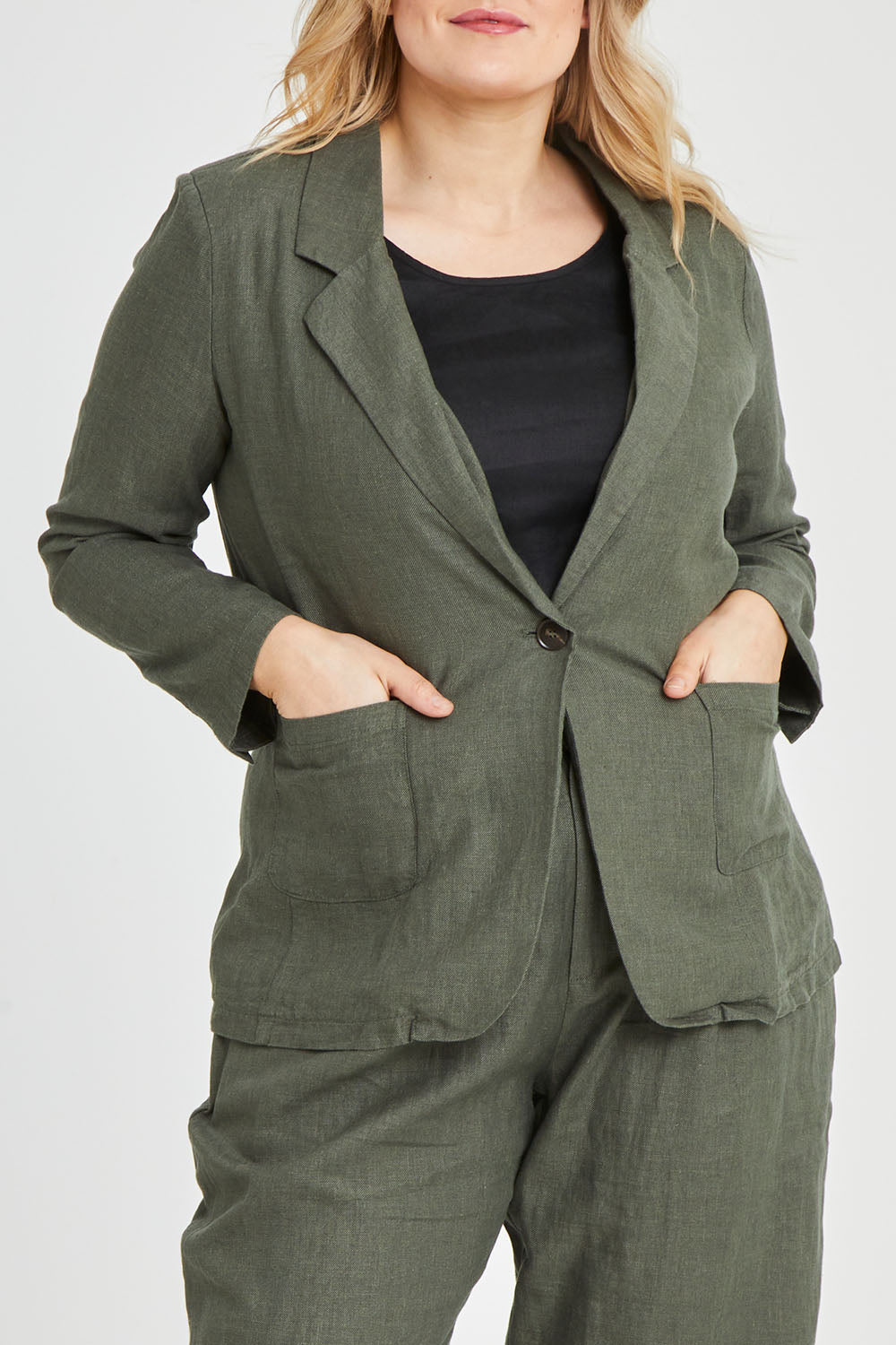 Model Keeara wearing size 16 of the Cotton Linen Longline Blazer in colour Olive (Green), from the front, cropped image