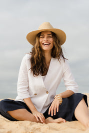 Model Ilona wearing size 10 of the Linen 3/4 Sleeve Blazer in colour Meringue (White), from the front, showing the whole outfit