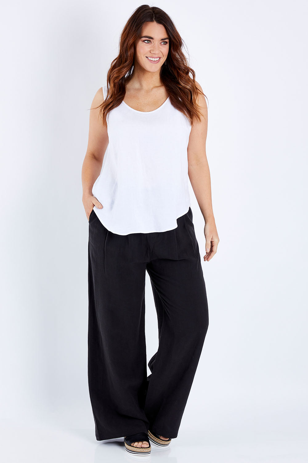 Model Laura wearing size 14 of the Linen Scoop Neck Top in colour Salt (White), from the front, showing the whole outfit