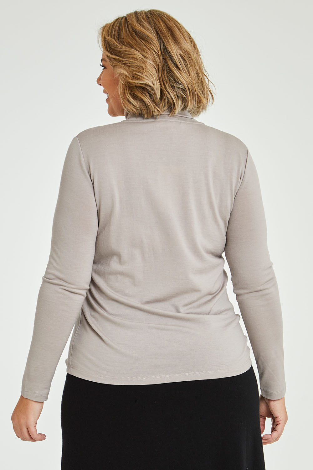 Model Fiona wearing size 16 of the Merino Wool Skivvy in colour Natural, from the back