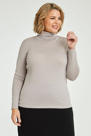 Model Fiona wearing size 16 of the Merino Wool Skivvy in colour Natural, from the front, cropped image