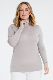 Model Jess wearing size 14 of the Merino Wool Skivvy in colour Natural, from the front, cropped image
