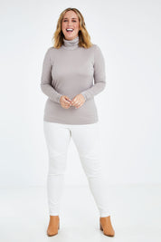 Model Jess wearing size 14 of the Merino Wool Skivvy in colour Natural, from the front, showing the whole outfit