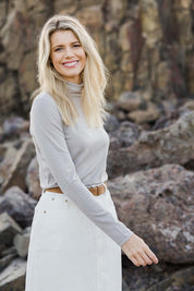 Model Kelly wearing size 10 of the Merino Wool Skivvy in colour Natural, from the front, showing the whole outfit