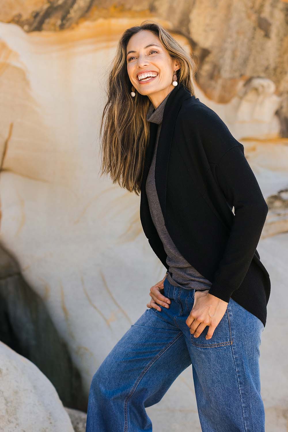 Model Amanda wearing size S of the Merino Wool Cocoon Cardigan in colour Black (Black), from the front, showing the whole outfit