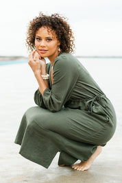 Model Lala wearing size 10 of the Ramie Empire Line Dress in colour Green (Green), from the front, showing the whole outfit