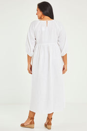 Model Terri-Leigh wearing size 14 of the Linen Gathered Waist Dress in colour White (White), from the back