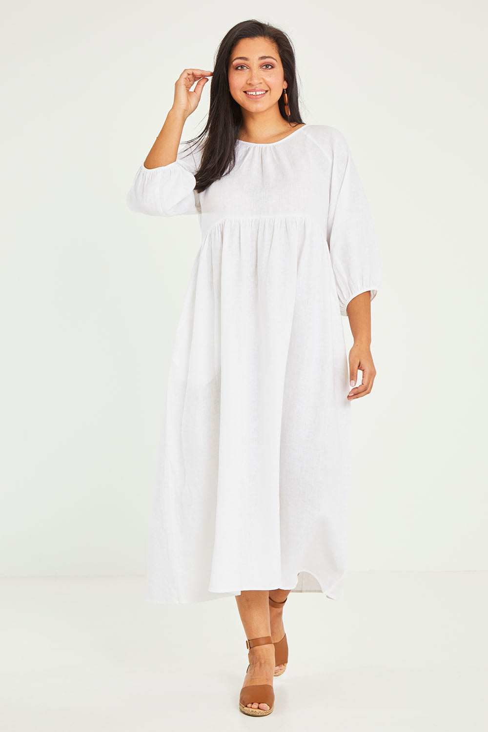 Model Terri-Leigh wearing size 14 of the Linen Gathered Waist Dress in colour White (White), from the front, showing the whole outfit