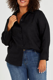 Model Alexis wearing size 16 of the Linen Oversized Boyfriend Shirt in colour Black (Black), from the front, cropped image