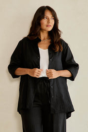 Model Tahnee wearing size 10 of the Linen Oversized Boyfriend Shirt in colour Black (Black), from the front, cropped image