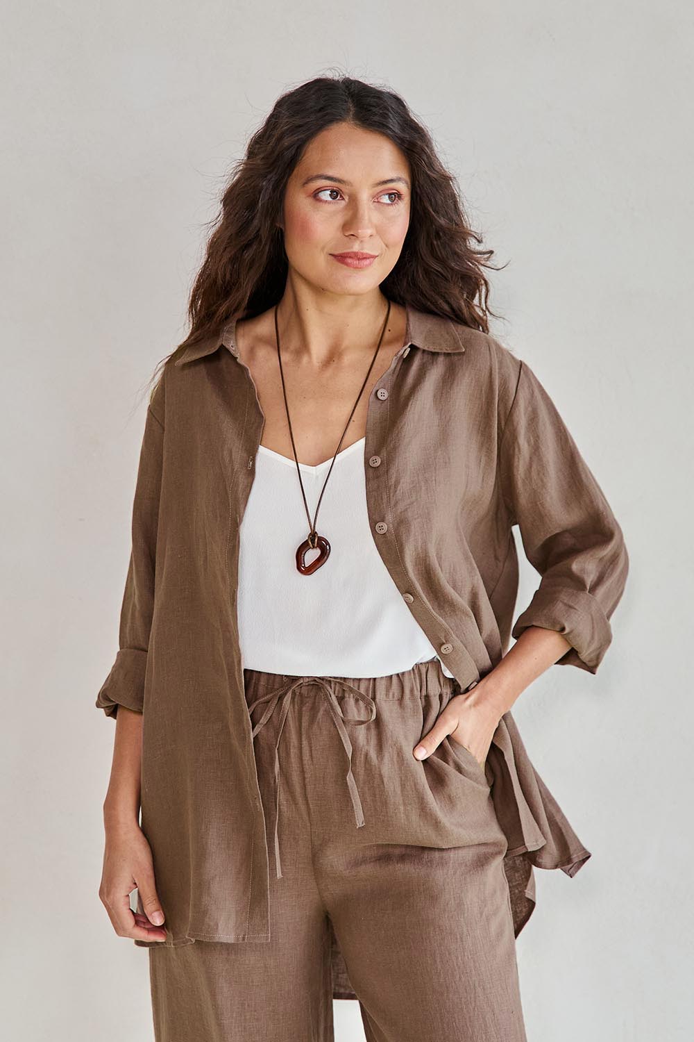 Model Tahneei wearing size 10 of the Linen Oversized Boyfriend Shirt – Coffee in colour Coffee, in a cropped view