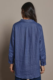 Model Amanda wearing size 10 of the Linen Oversized Boyfriend Shirt in colour Denim (Blue), from the back