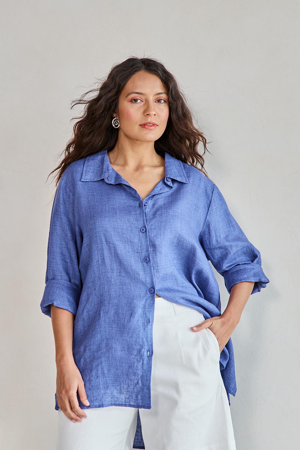 Model Tahneei wearing size 10 of the Linen Oversized Boyfriend Shirt - Denim in colour Denim, in a cropped view