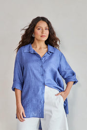 Model Tahneei wearing size 10 of the Linen Oversized Boyfriend Shirt - Denim in colour Denim, in a cropped view
