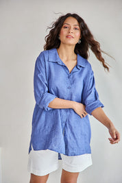 Model Tahneei wearing size 10 of the Linen Oversized Boyfriend Shirt - Denim in colour Denim, in a cropped view