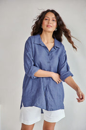 Model Tahneei wearing size 10 of the Linen Oversized Boyfriend Shirt - Denim in colour Denim, in a cropped view