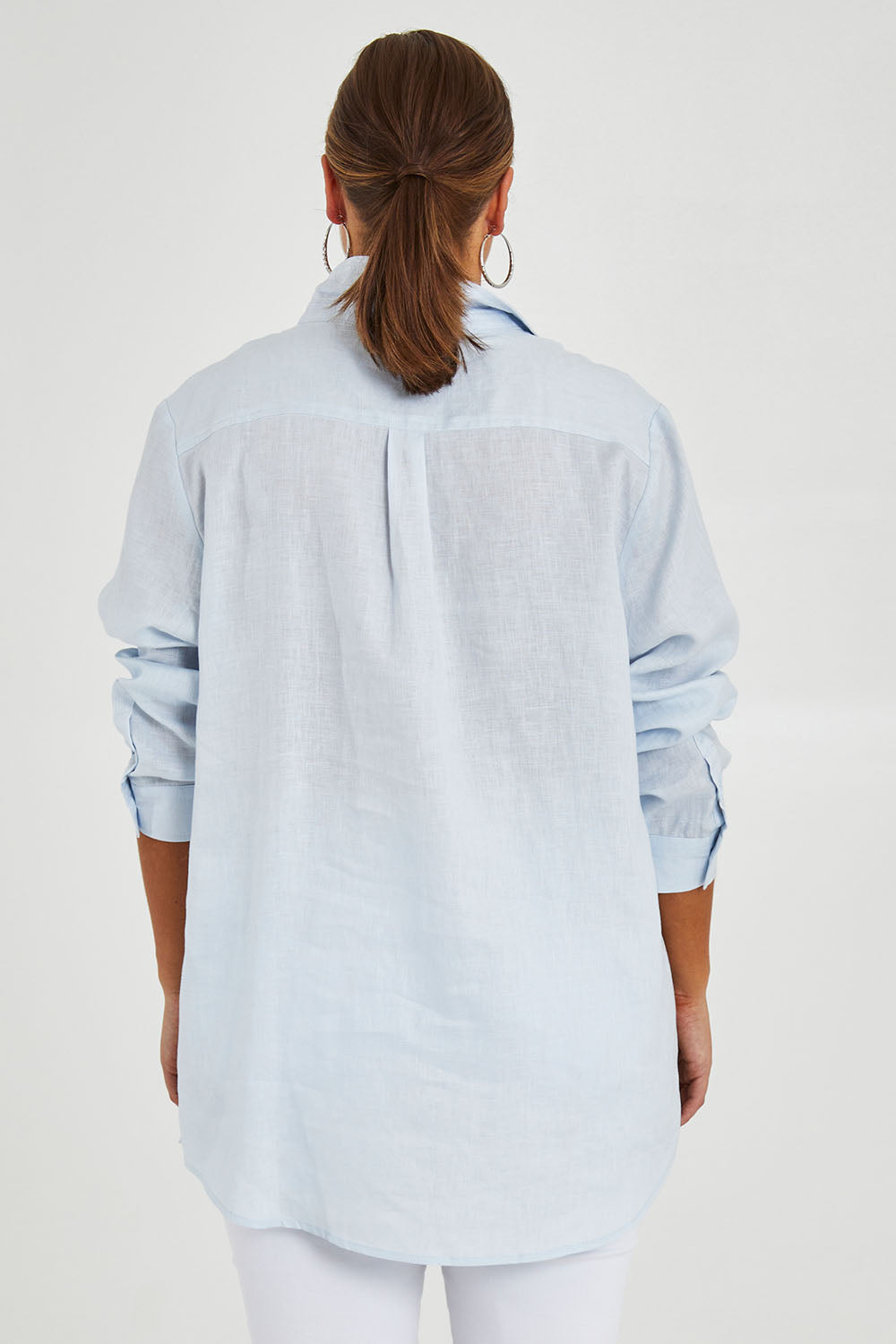 Model Monique wearing size 14 of the Linen Oversized Boyfriend Shirt in colour Lightblue (Blue), from the back