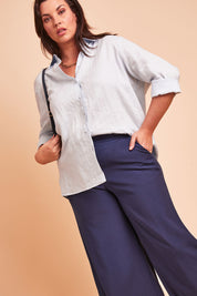 Model Poppy wearing size 16 of the Linen Oversized Boyfriend Shirt in colour Lightblue (Blue), from the front, showing the whole outfit