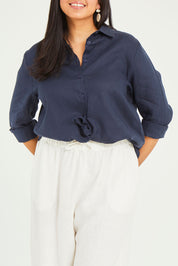 Model Terri-Leigh wearing size 14 of the Linen Oversized Boyfriend Shirt in colour Navy (Blue), from the front, cropped image