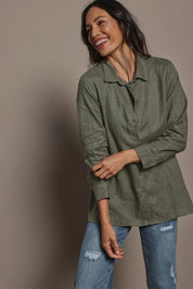 Model Amanda wearing size 10 of the Linen Oversized Boyfriend Shirt in colour Olive (Green), from the front, cropped image
