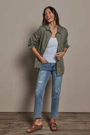 Model Amanda wearing size 10 of the Linen Oversized Boyfriend Shirt in colour Olive (Green), from the front, showing the whole outfit