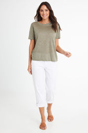 Model Madeline wearing size 10 of the Linen Scoop Neck Top in colour Green (Green), from the front, showing the whole outfit
