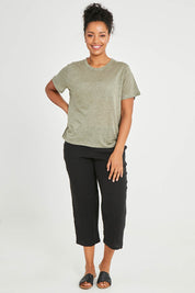 Model Noli wearing size 14 of the Linen Scoop Neck Top in colour Green (Green), from the front, showing the whole outfit