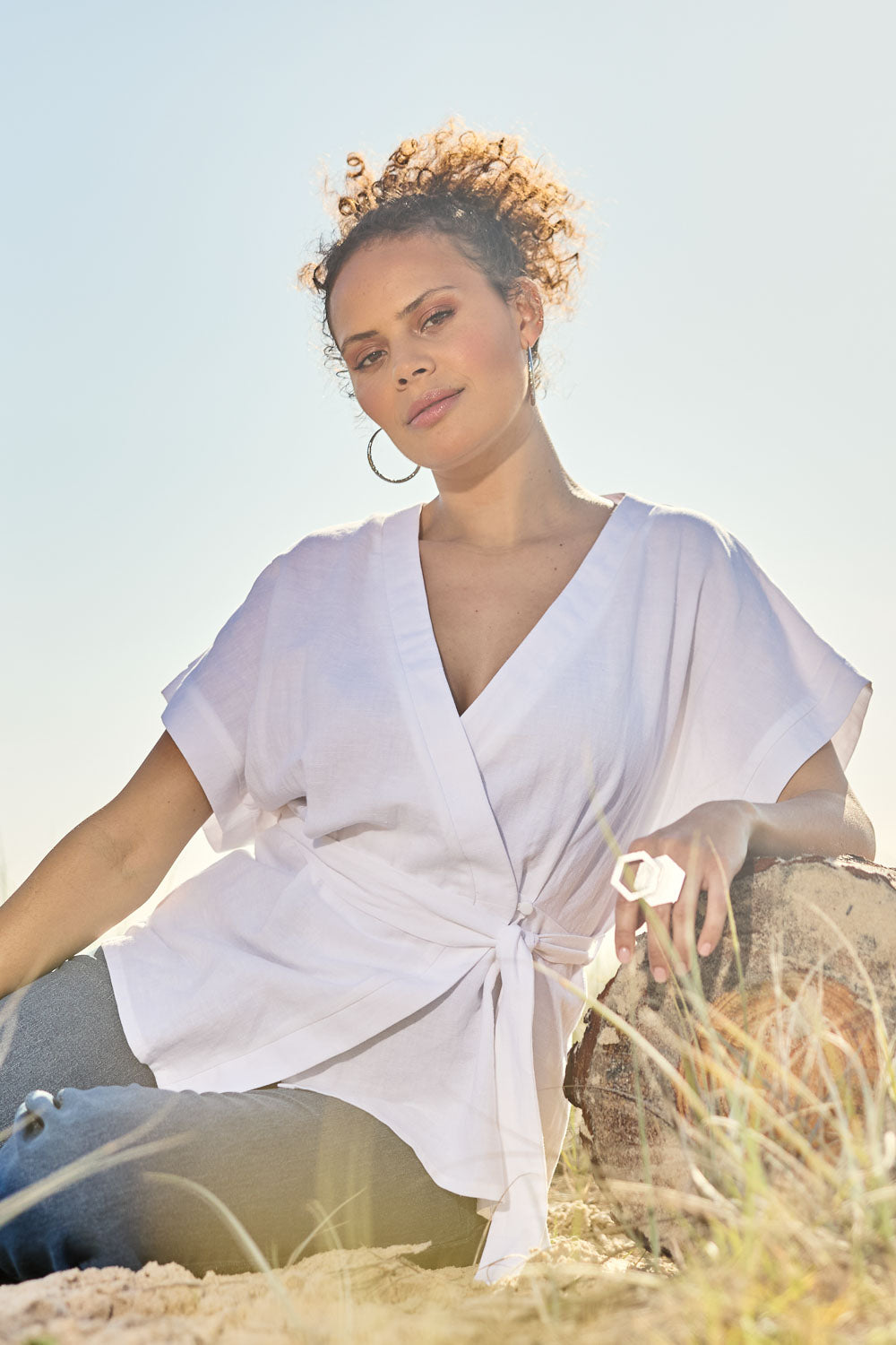 Model Lala wearing size 10 of the Linen Cotton Wrap Blouse in colour White (White), from the front, showing the whole outfit