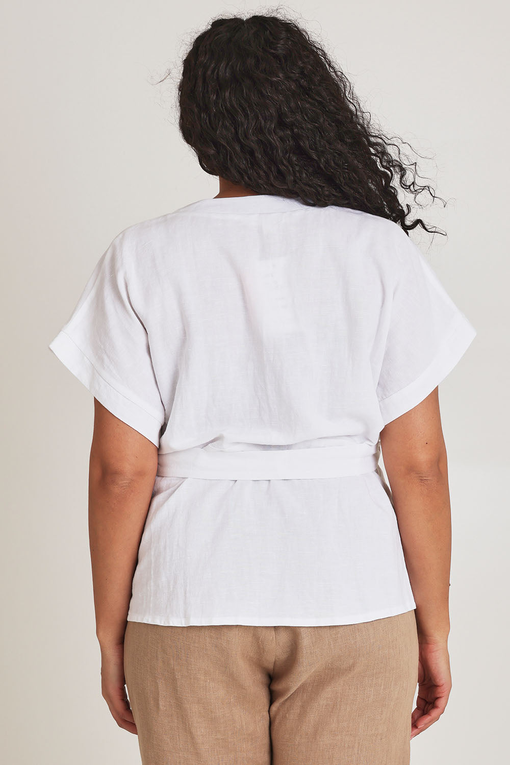 Model Terri-Leigh wearing size 14 of the Linen Cotton Wrap Blouse in colour White (White), from the back