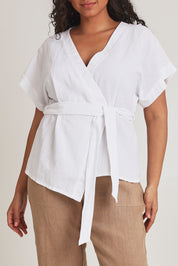 Model Terri-Leigh wearing size 14 of the Linen Cotton Wrap Blouse in colour White (White), from the front, cropped image