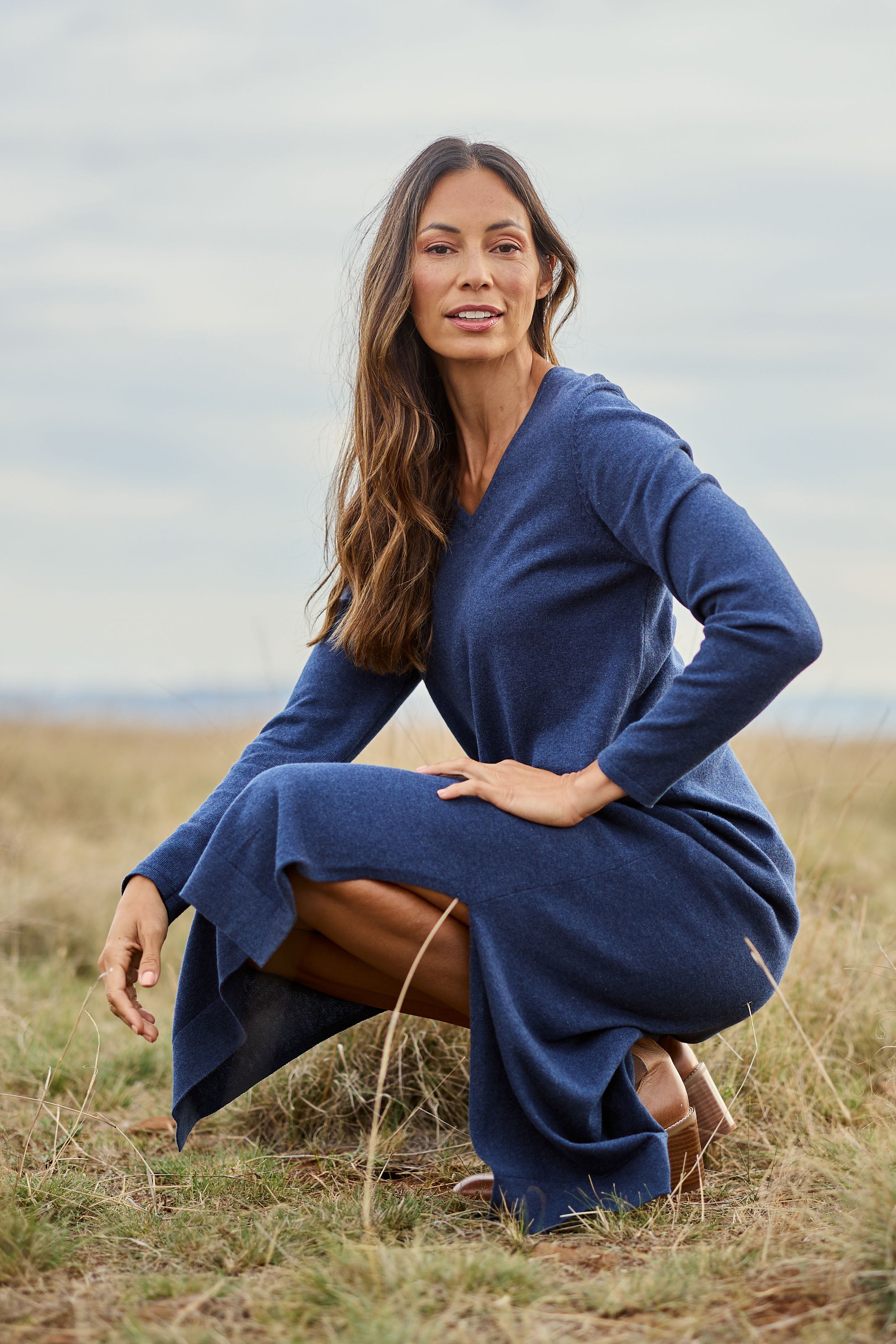 Model Amanda wearing size S of the Cotton Cashmere Wool V Neck Knit Dress in colour Marlin (Blue), from the front, showing the whole outfit