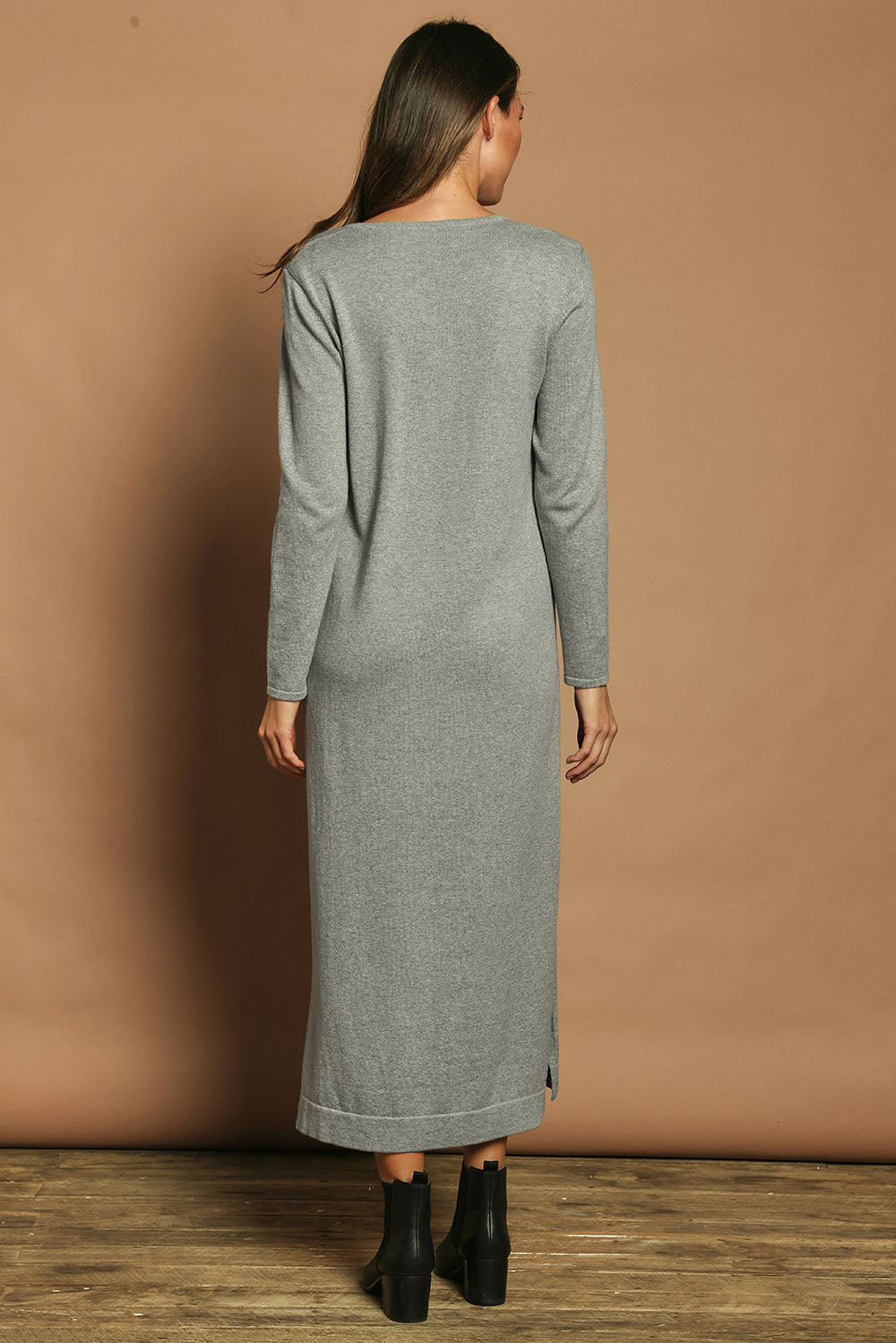 Model Madeline wearing size S of the Cotton Cashmere Wool V Neck Knit Dress in colour Opalgrey (Grey), from the back