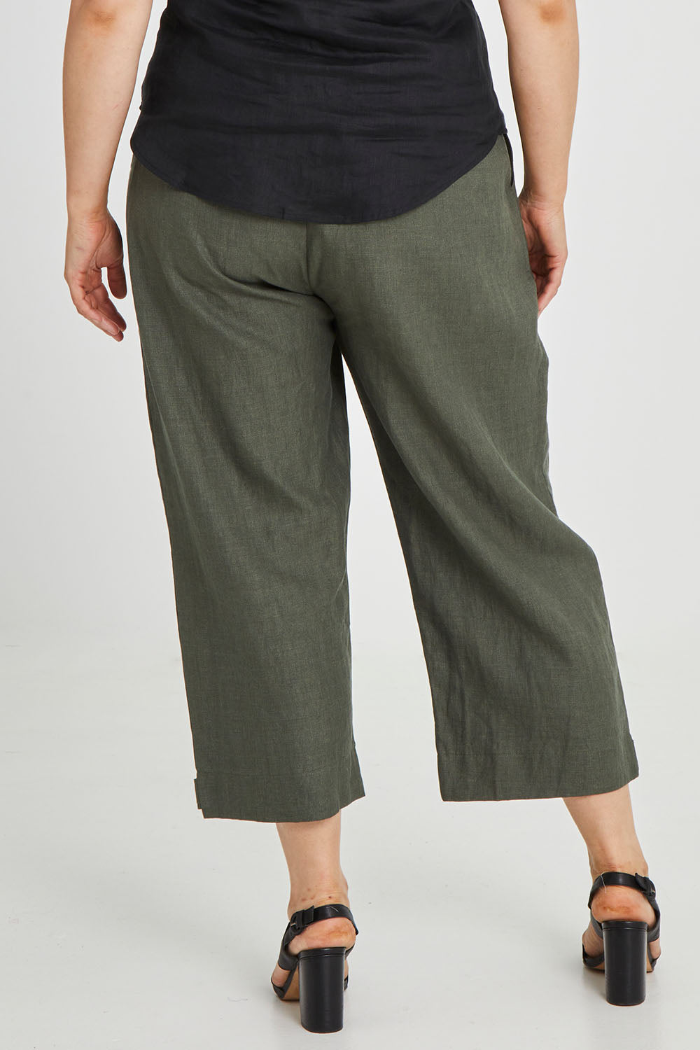 Model Keeara wearing size 16 of the Linen Cotton 7/8 Pant in colour Olive (Green), from the back