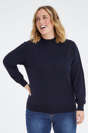 Model Jess wearing size L of the Merino Wool High Crew Pullover in colour Navy (Blue), from the front, cropped image