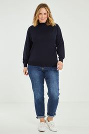 Model Jess wearing size L of the Merino Wool High Crew Pullover in colour Navy (Blue), from the front, showing the whole outfit