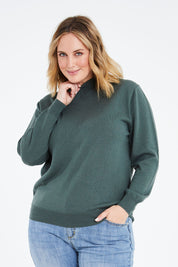 Model Jess wearing size L of the Merino Wool High Crew Pullover in colour Seafoam (Green), from the front, cropped image