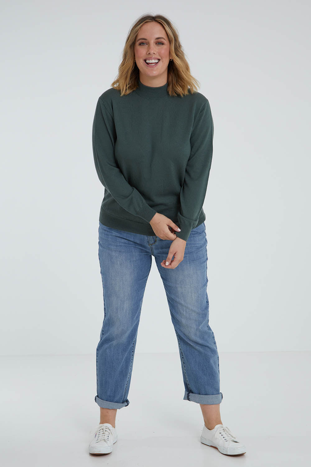 Model Jess wearing size L of the Merino Wool High Crew Pullover in colour Seafoam (Green), from the front, showing the whole outfit