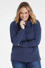 Model Jess wearing size L of the Wool Rolled Neck Jumper in colour Denim (Blue), from the front, cropped image